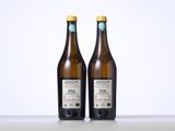 two bottles of wine sitting on top of a table next to each other