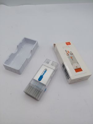 a toothbrush, toothpaste, and toothpaste holder on a table