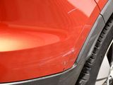a close up of a red car ' s front bumper