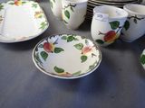 a lot of plates and cups that are on a table