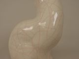 a white cat figurine sitting on a table