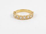 a gold ring with three diamonds on the side