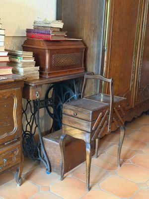une chaise et une table sur laquelle sont posés des livres, dans une pièce