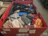 a red box full of clothes on display in a store