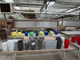 many different colored vases on a table in a warehouse