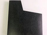 a close up of a piece of black paper on a white surface