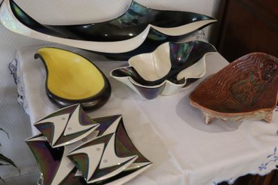 a white table with a white table cloth and a white table cloth with black and white plates and bowls on it