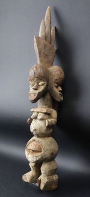 an image of a wooden sculpture of a bird and a bird on top of it