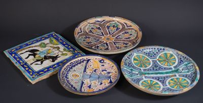 three decorative plates with designs on them on a black surface