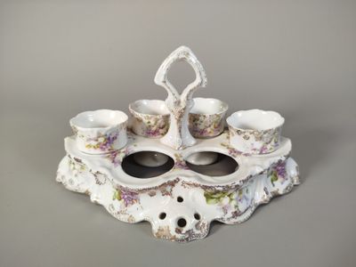 a picture of a porcelain tea set with cups and saucers
