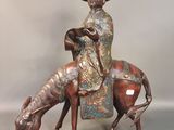 figurine en bronze représentant un homme à cheval, coiffé d'un chapeau