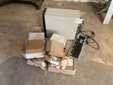 many boxes and a laptop on the floor next to a chair