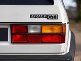 a close up of a golf gti car parked on the side of the road