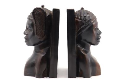 pair of bookends in the shape of a woman ' s head and a man ' s head