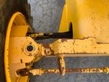 a close up of a yellow wheel on a tractor
