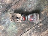 a small bottle on a wooden table with a toothbrush