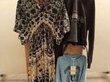 a display of clothing on a wooden stand in a room