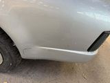 a close up of a car ' s front bumper with a denting on it