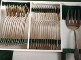 a tray with silverware in it and a fork in it