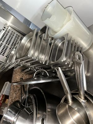de nombreuses casseroles et poêles suspendues au plafond de la cuisine