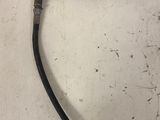 a close up of a hose attached to a wall on a tiled floor