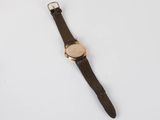 a close up of a wrist watch on a white surface