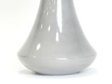 a white vase that is sitting on a table