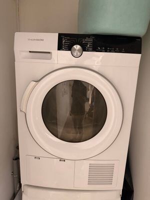 a washer and dryer in the corner of a room