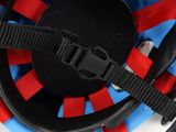 a close up of a helmet with a red and blue stripe