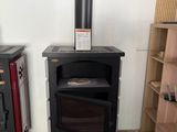 two wood burning stoves in the corner of a room