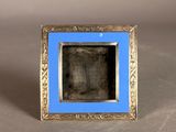 an old picture frame with a blue border on a gray surface