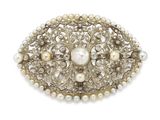 pearl and silver broochle with pearls on a white background