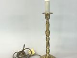 an image of a brass table lamp with a cord plugged into it