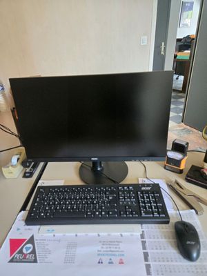 a computer monitor and keyboard sitting on a desk