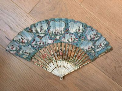 a fan sitting on a wooden floor on the floor
