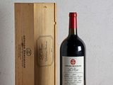 a bottle of wine sitting next to a wooden box
