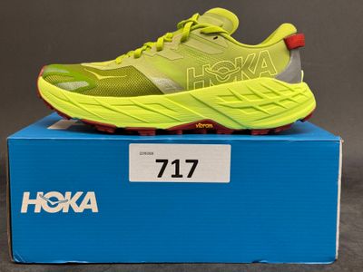 the shoe is in a box on a gray surface