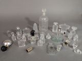 a lot of perfume bottles and a bottle of perfume on a table