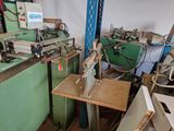 a machine that is sitting in a room with many pieces of wood
