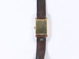 wrist watch with brown leather strap and gold plated case