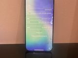 the back of a black phone sitting on top of a black table
