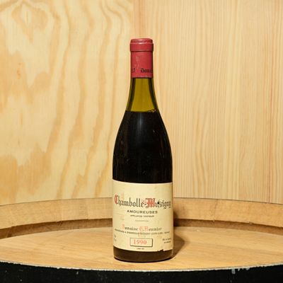 a bottle of wine sitting on top of a barrel