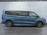 the blue van is parked in a garage with a white wall behind it