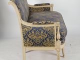 a blue and gold chair sitting on a white floor