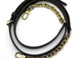 a close up of a black leather bracelet with a gold chain