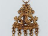 a gold plated pendant with a cross on a chain