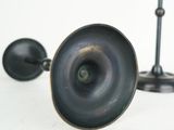 a close up of a metal object on a white surface