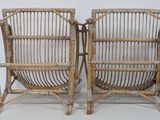pair of bamboo chairs with arms and legs made of wood