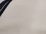 a close up of a white shirt with a black stripe on it