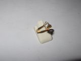 a close up of a gold ring with a diamond on it